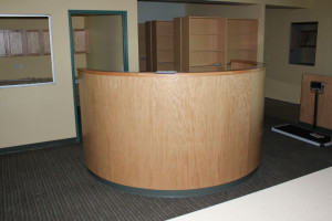 Reception desk with curved wood front